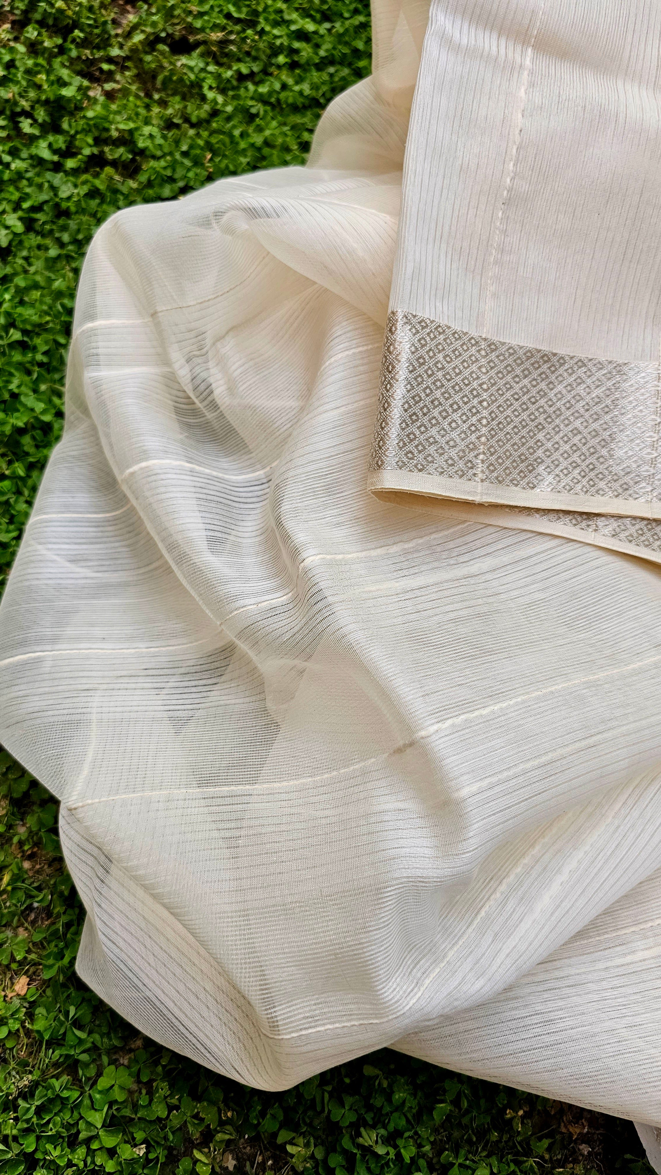 Off White Saree with self Weft Stripes and Silver Zari Borders.