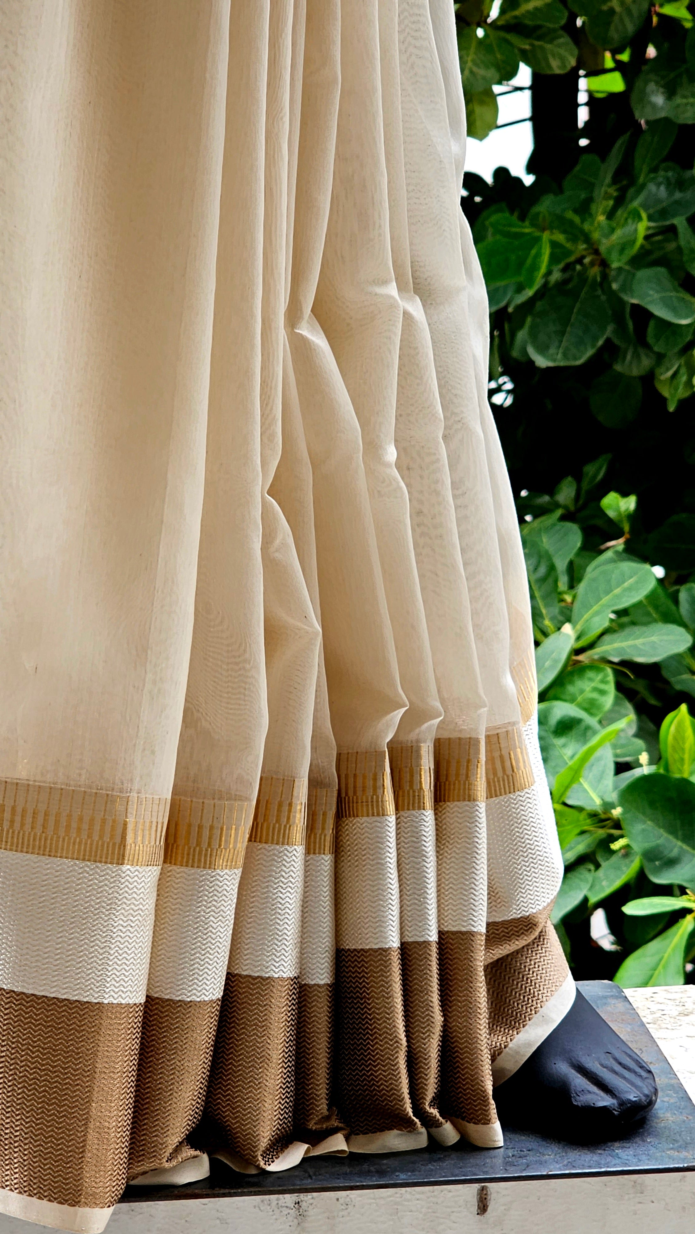 An Off White Saree with Broad Resham Borders.