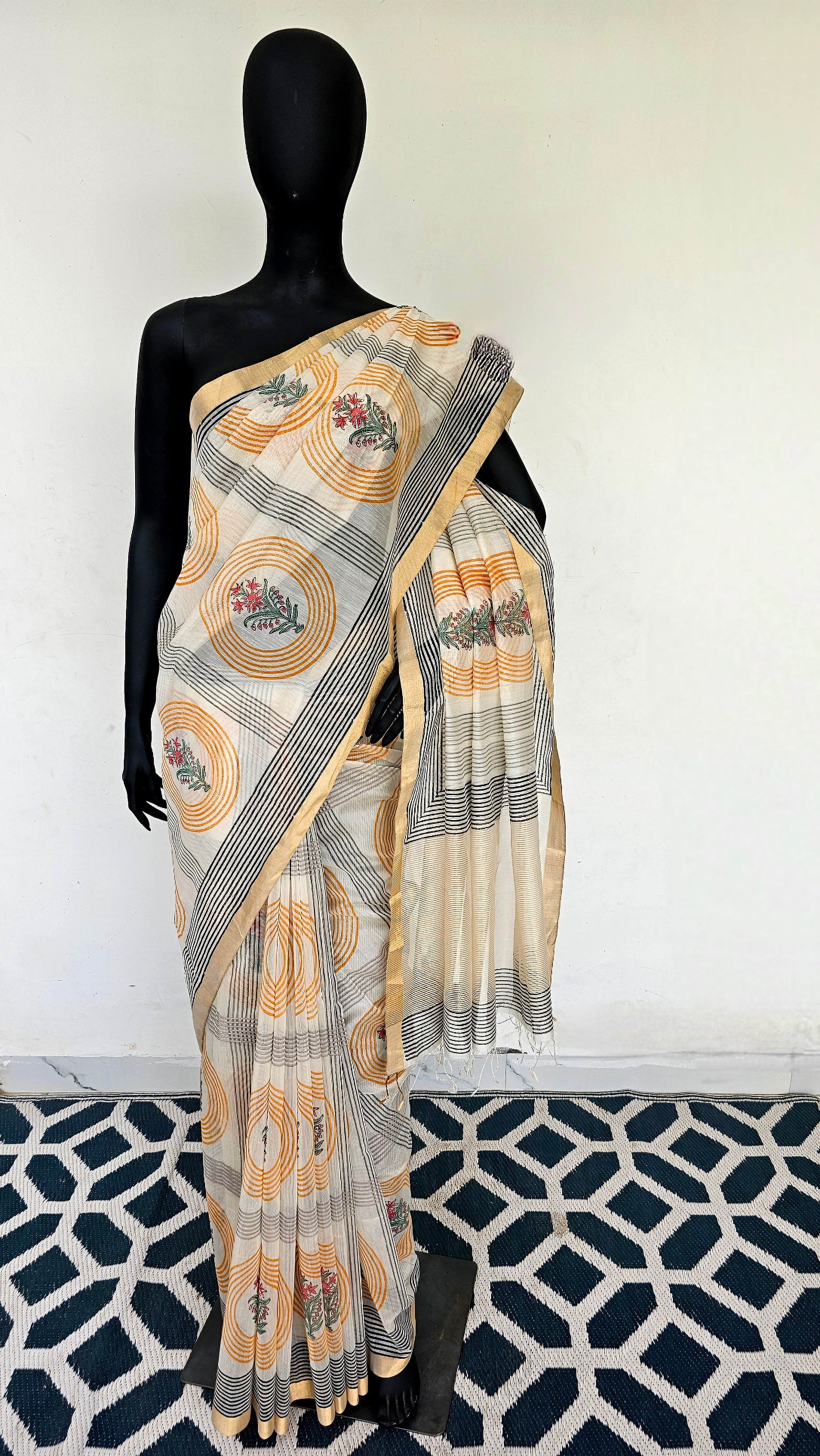 Saree with Hand Block prints and flat Gold Zari Borders.