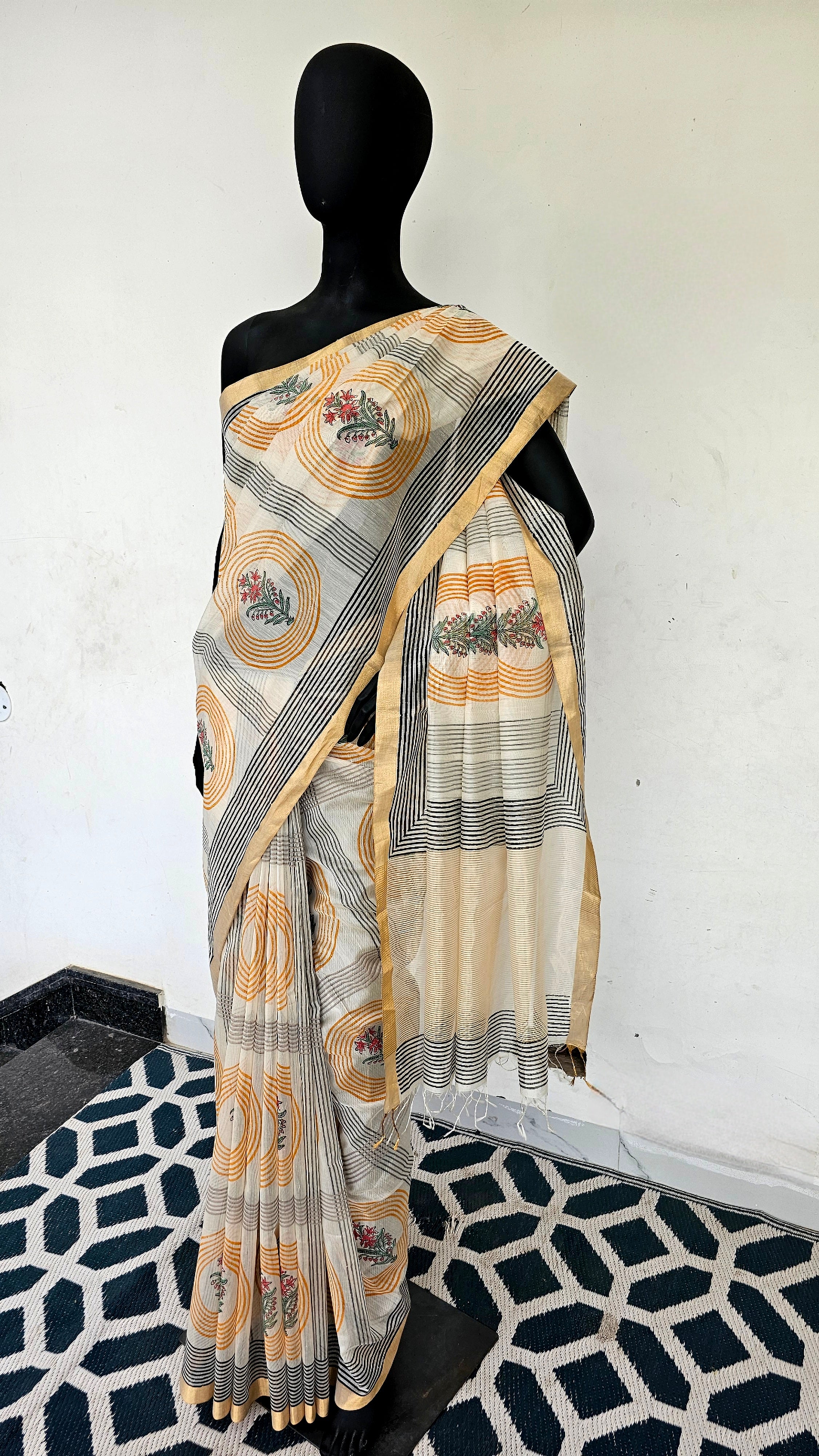 Saree with Hand Block prints and flat Gold Zari Borders.