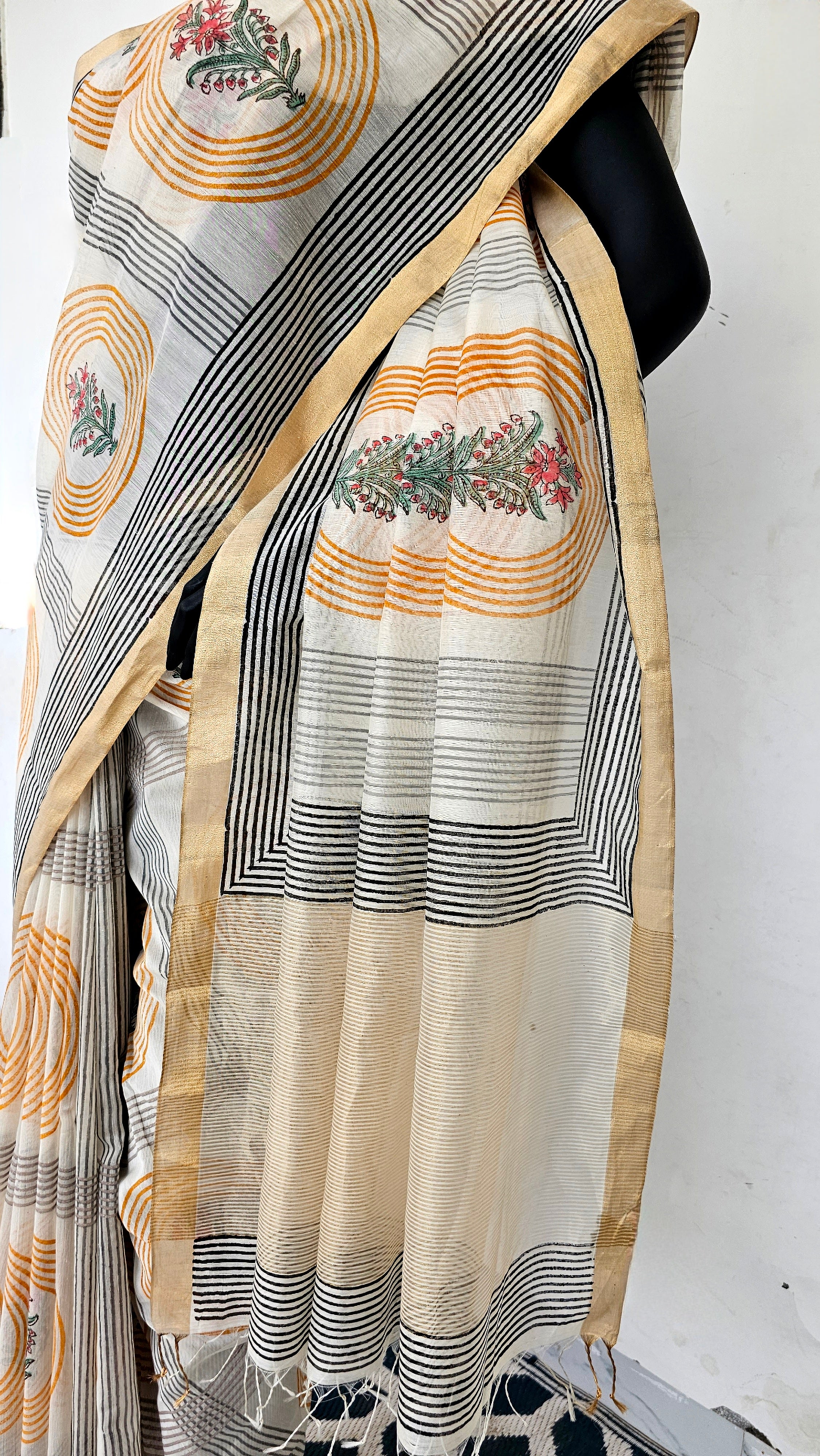 Saree with Hand Block prints and flat Gold Zari Borders.