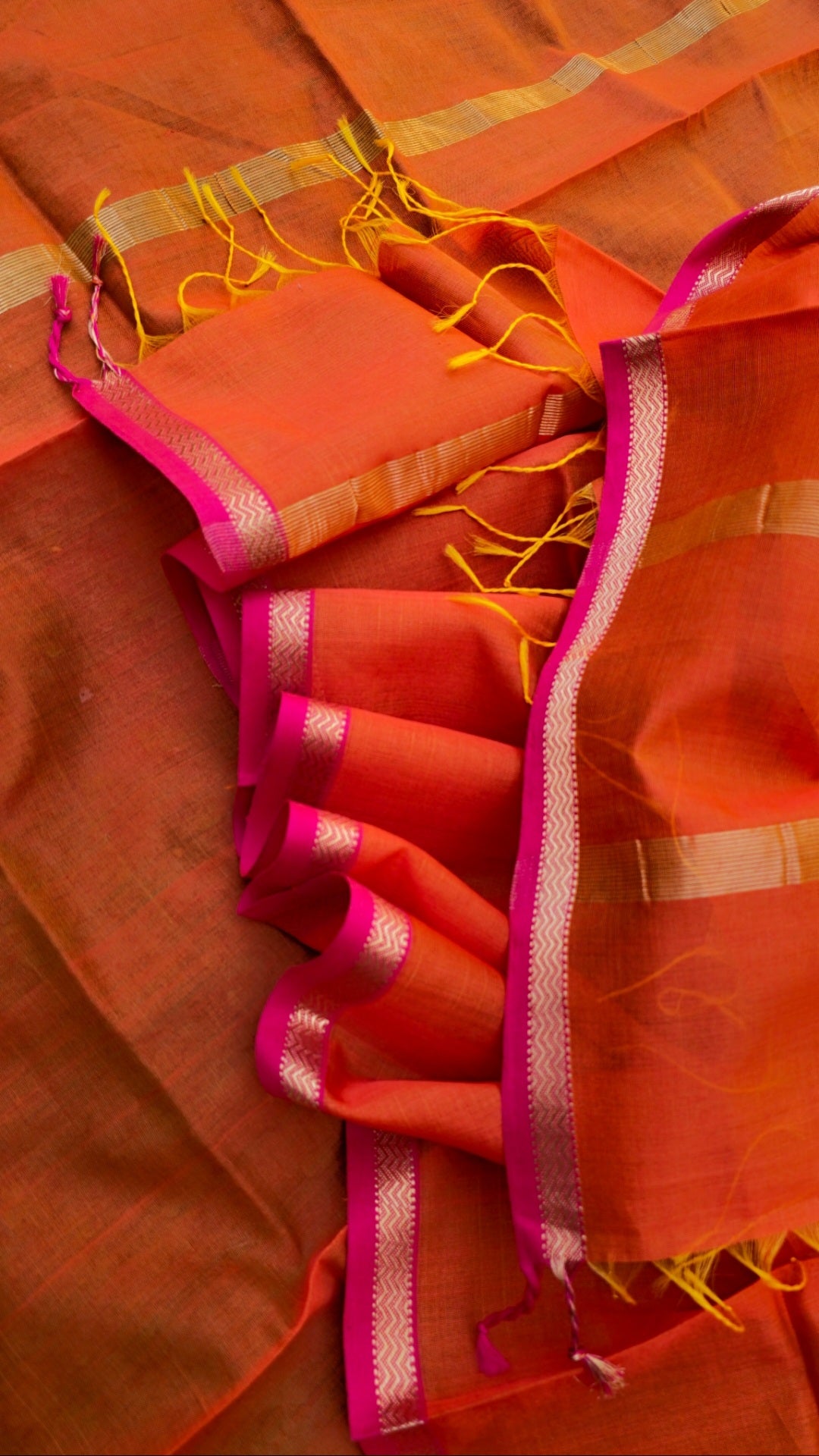 Dupatta in Burnt Orange shade with Pink/Gold Borders.